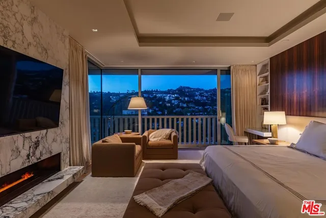a balcony with furniture and a flat screen tv