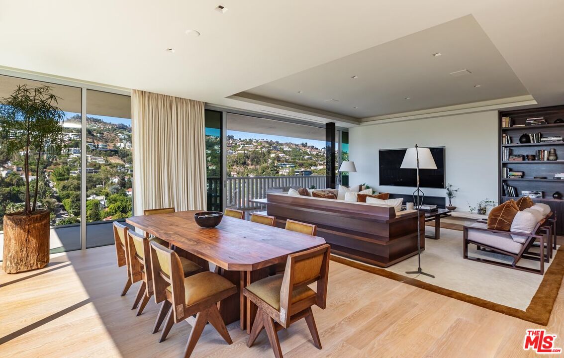 9255 Doheny Road, Unit 1901 West Hollywood, CA 90069 - Photo 4 of 23 a view of a dining room with furniture window and wooden floor