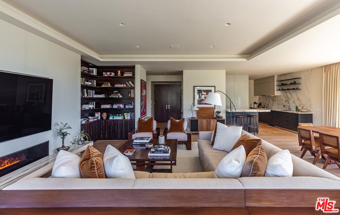 9255 Doheny Road, Unit 1901 West Hollywood, CA 90069 - Photo 7 of 23 a living room with furniture fireplace and flat screen tv