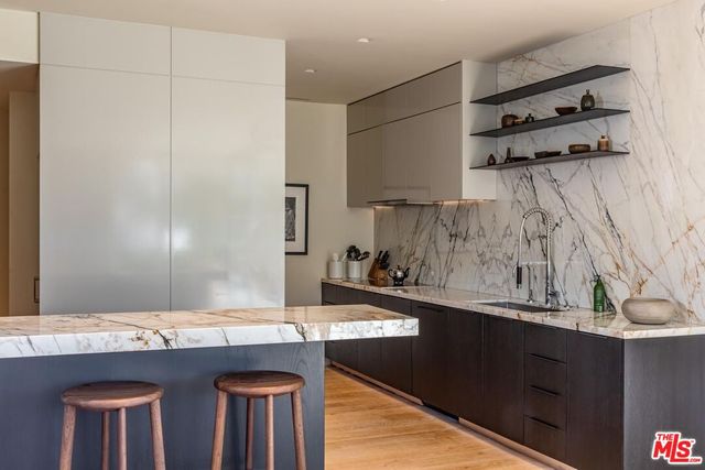 a kitchen with stainless steel appliances granite countertop a sink and cabinets
