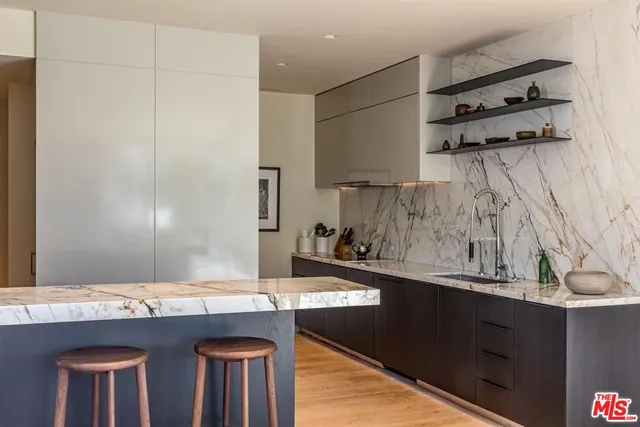 a kitchen with stainless steel appliances granite countertop a sink and cabinets