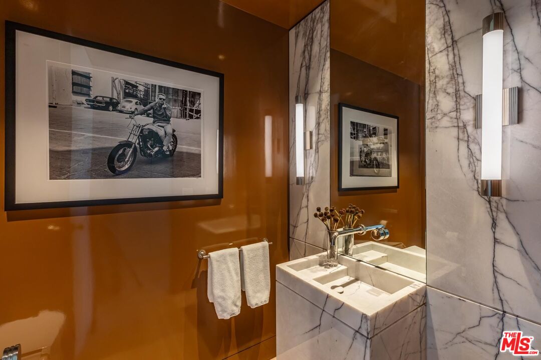 9255 Doheny Road, Unit 1901 West Hollywood, CA 90069 - Photo 10 of 23 a bathroom with a sink and mirror