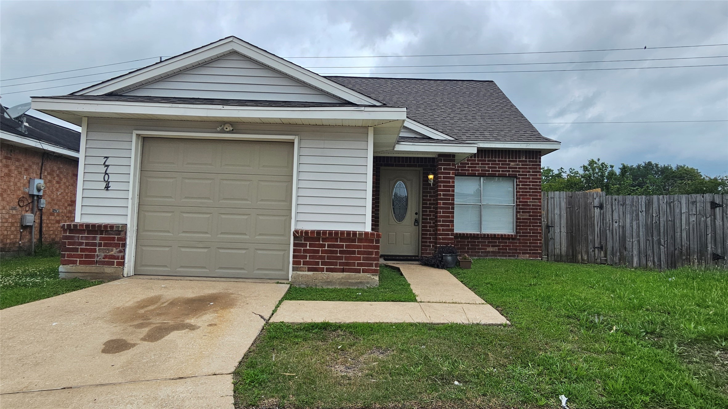 7704 Sign Street Houston, TX 77489 - Photo 1 of 27 a front view of a house with a yard