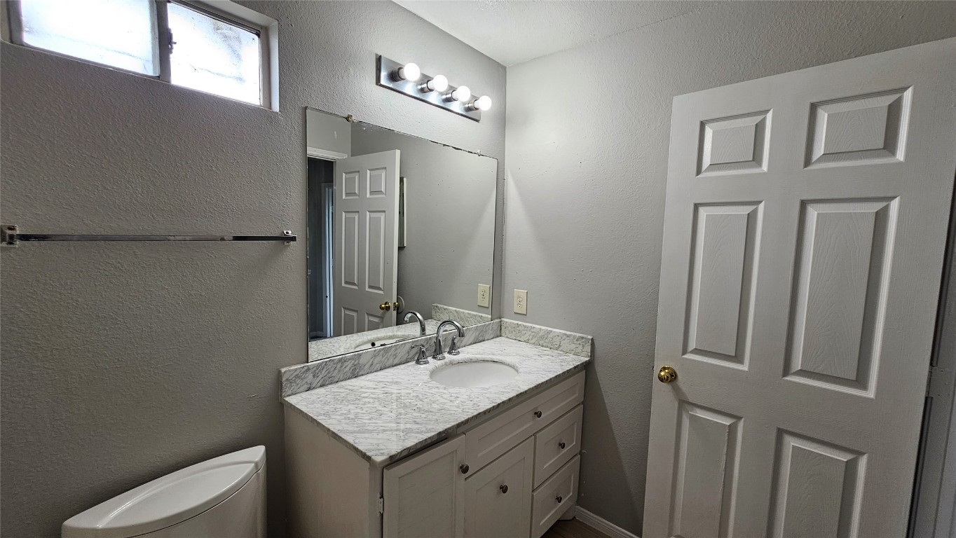 7704 Sign Street Houston, TX 77489 - Photo 18 of 27 a bathroom with a granite countertop sink and a mirror