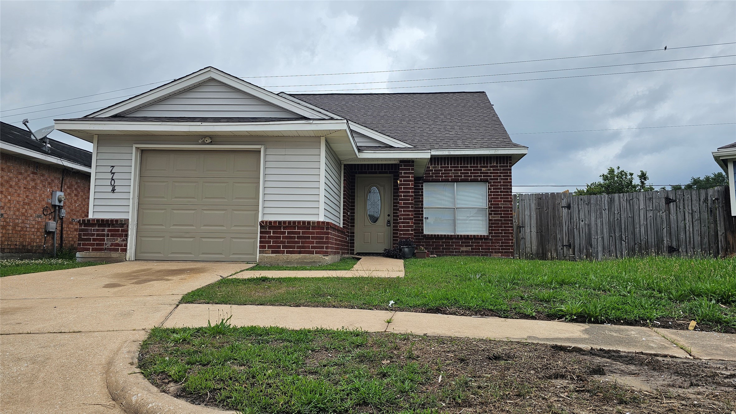 7704 Sign Street Houston, TX 77489 - Photo 2 of 27 a front view of a house with a yard and garage