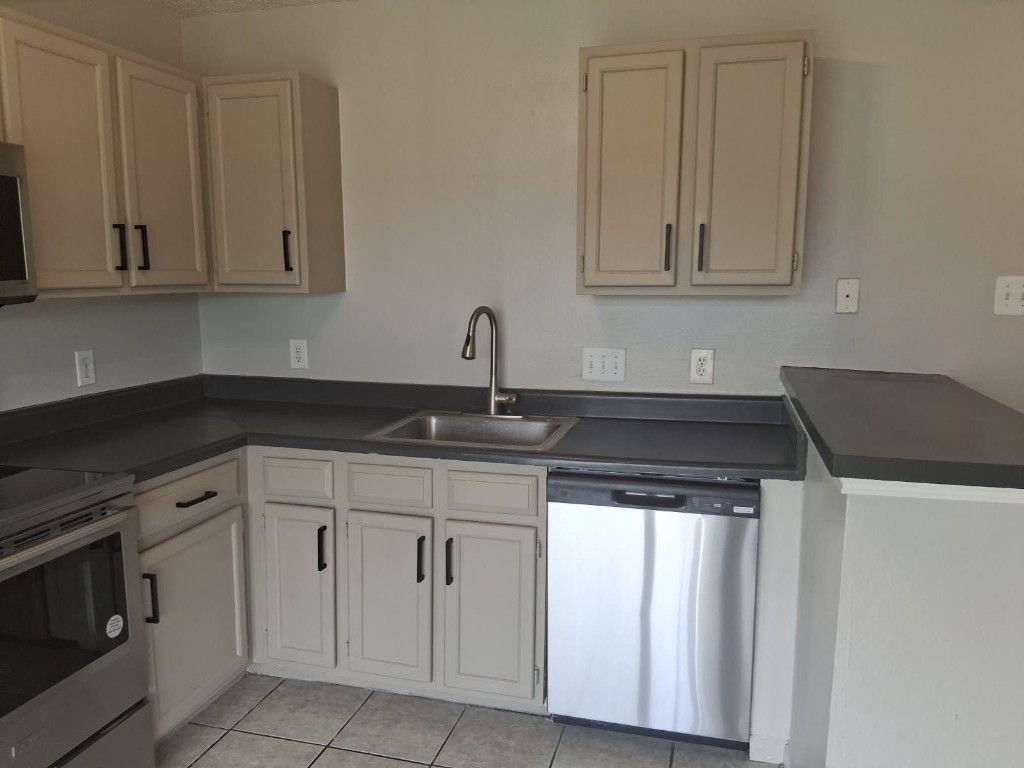 7704 Sign Street Houston, TX 77489 - Photo 9 of 27 a kitchen with white cabinets and sink