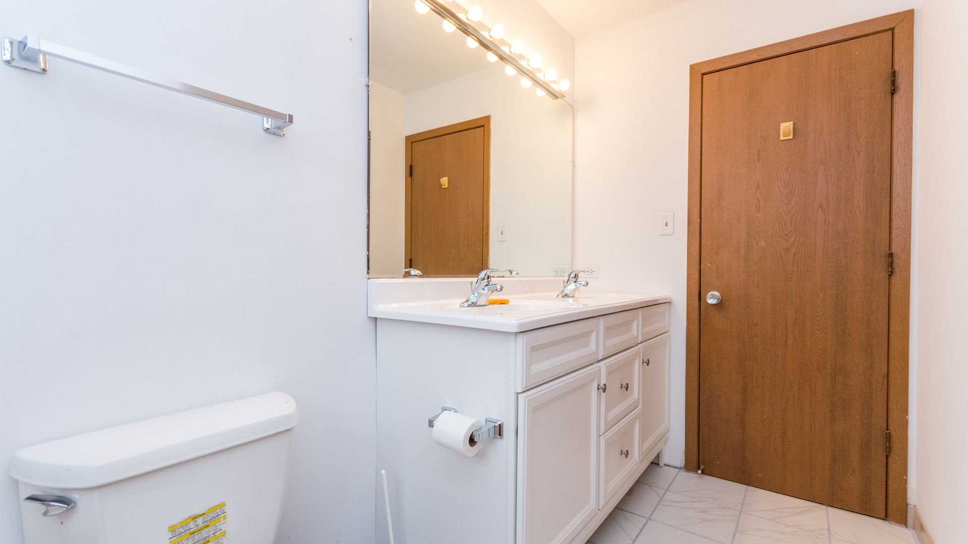 10205 South Springfield Avenue Chicago, IL 60655 - Photo 16 of 34 a bathroom with a double vanity sink a mirror and a toilet