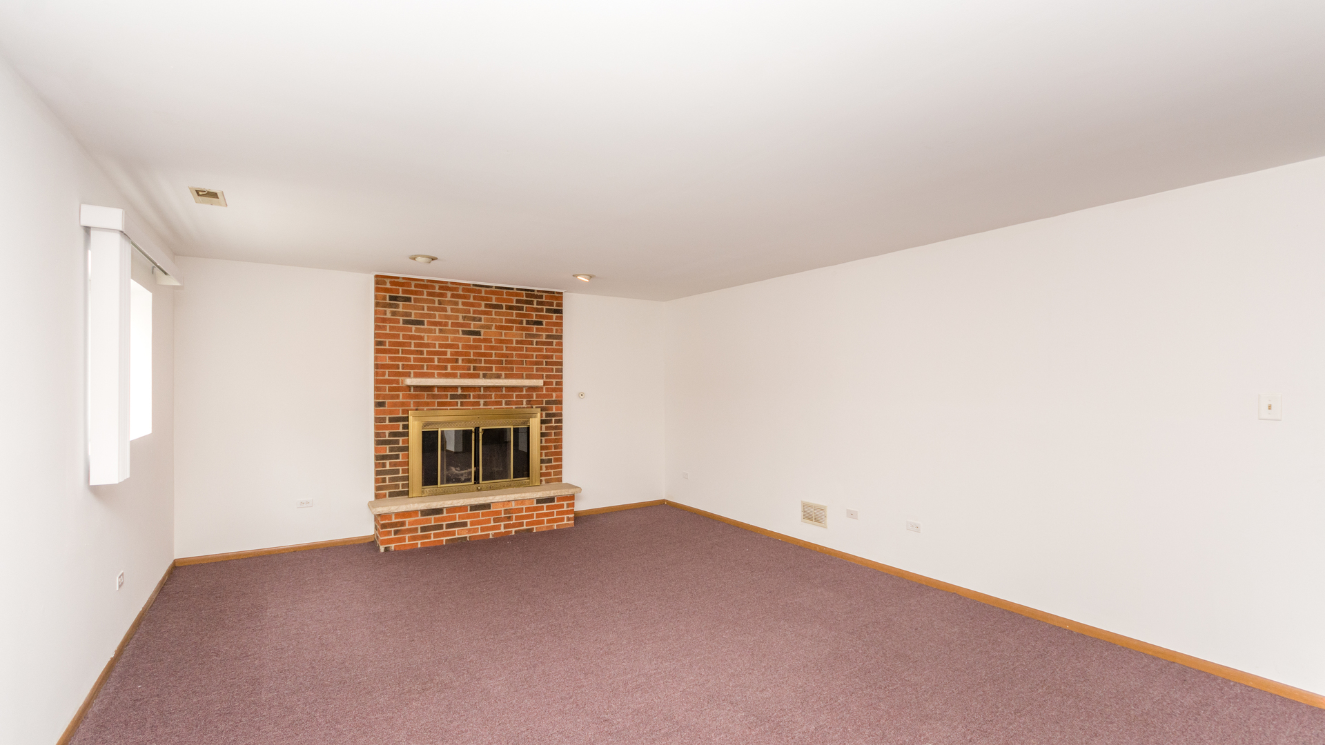 10205 South Springfield Avenue Chicago, IL 60655 - Photo 19 of 34 a view of an empty room with a fireplace and cabinet