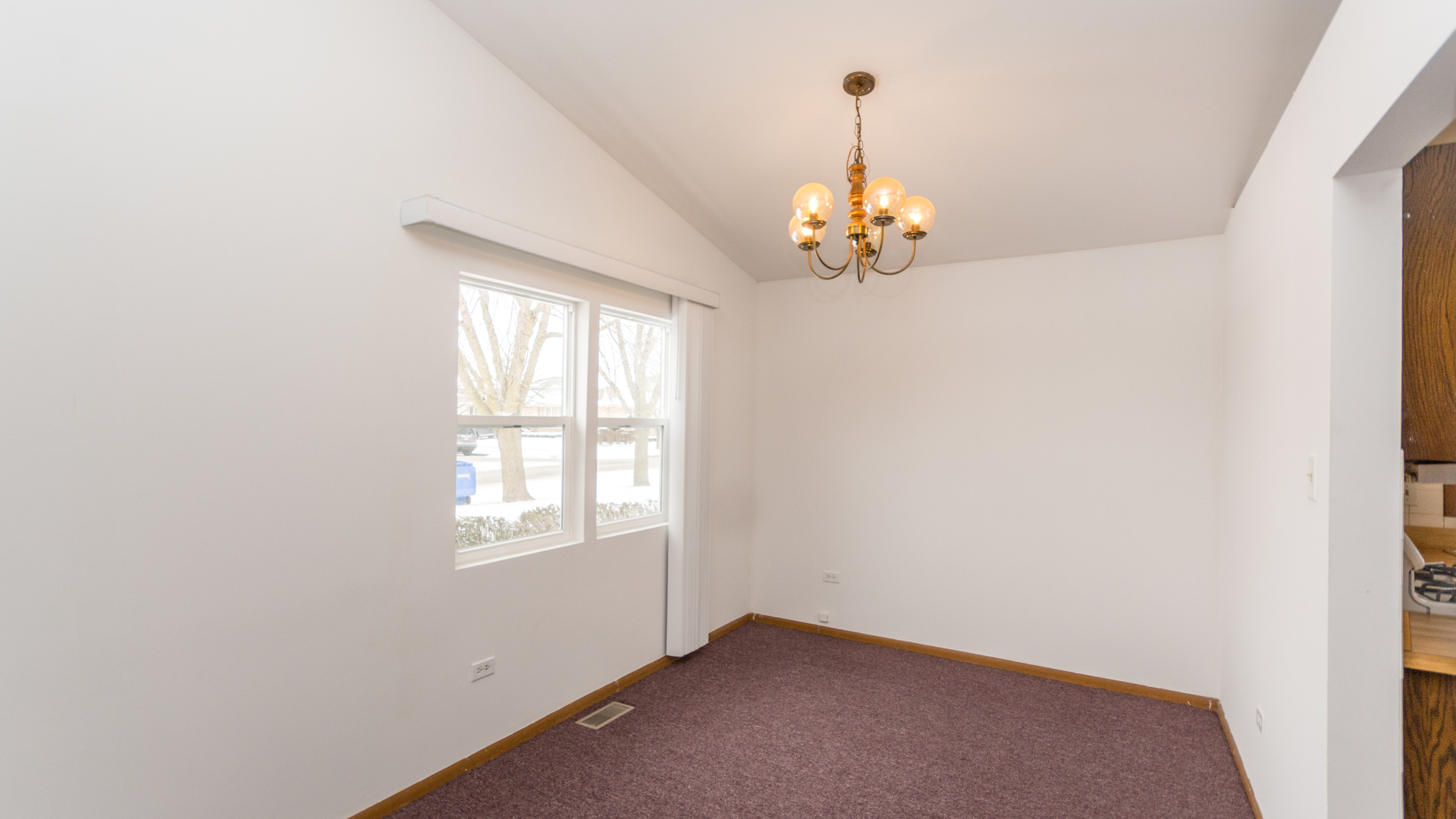 10205 South Springfield Avenue Chicago, IL 60655 - Photo 6 of 34 an empty room with chandelier fan and windows