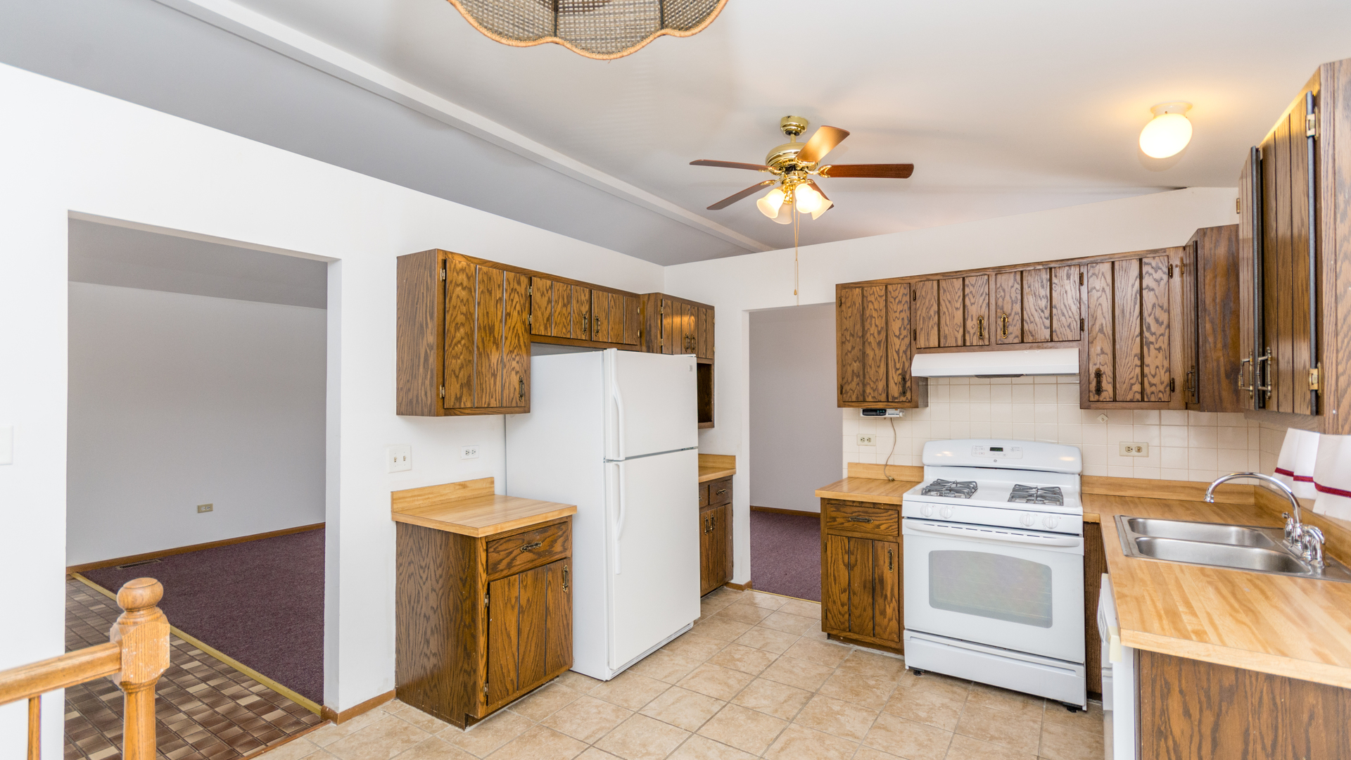 10205 South Springfield Avenue Chicago, IL 60655 - Photo 8 of 34 a kitchen with a stove top oven cabinets and a refrigerator
