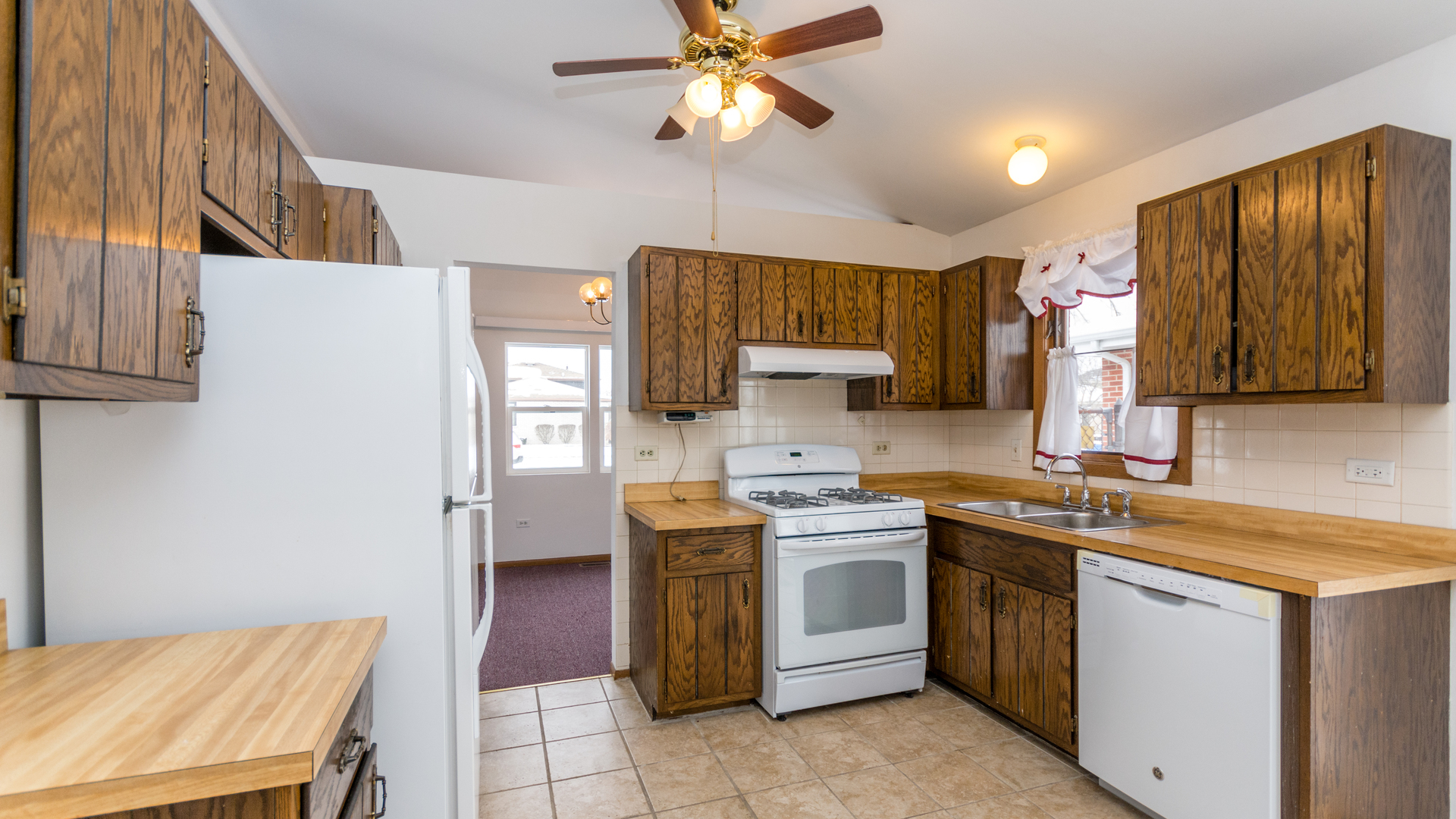 10205 South Springfield Avenue Chicago, IL 60655 - Photo 9 of 34 a kitchen with a sink a stove cabinets and a refrigerator