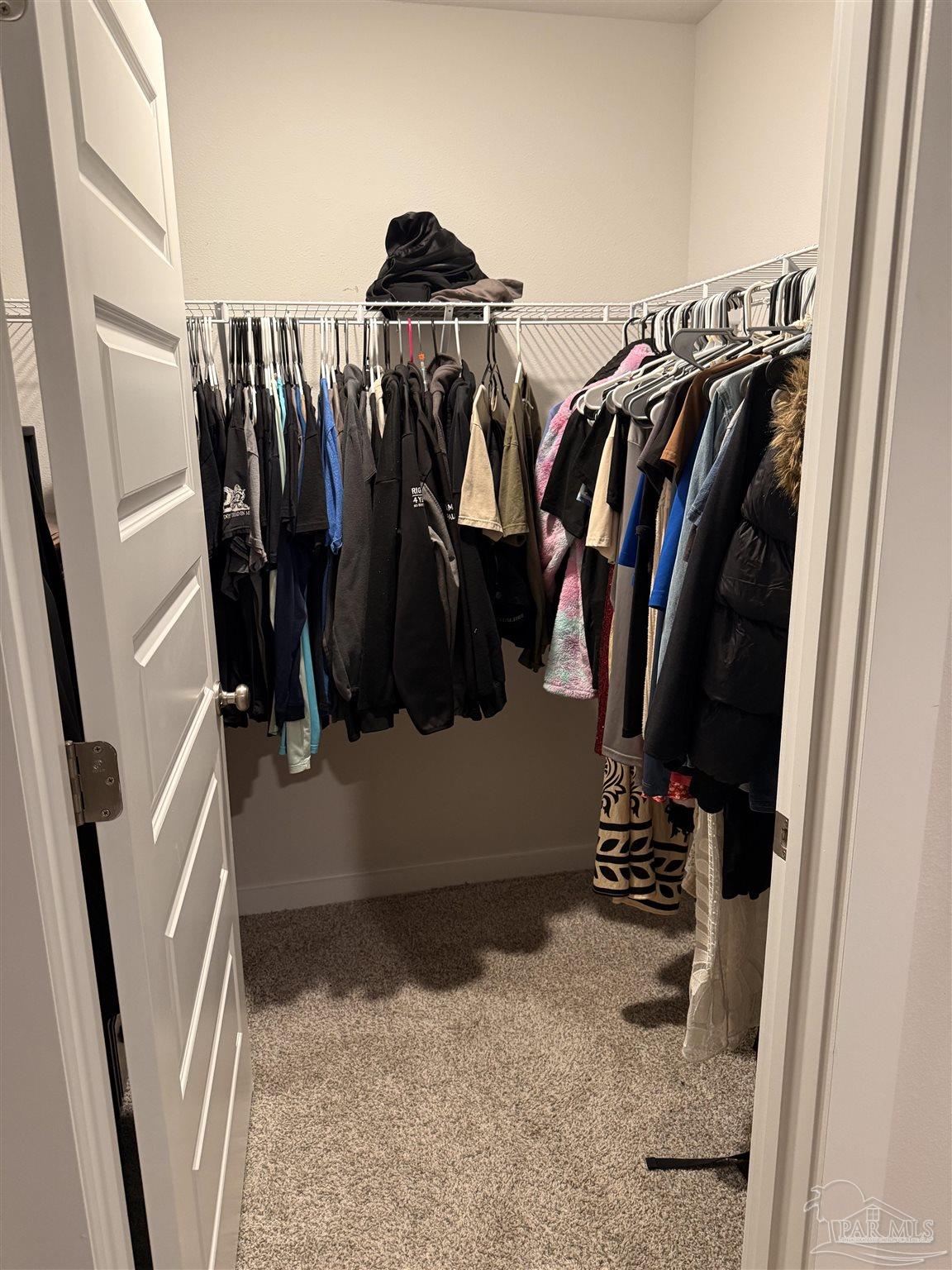 8 Spoonbill Street Cantonment, FL 32533 - Photo 15 of 22 a view of walk in closet with clothes and shoes
