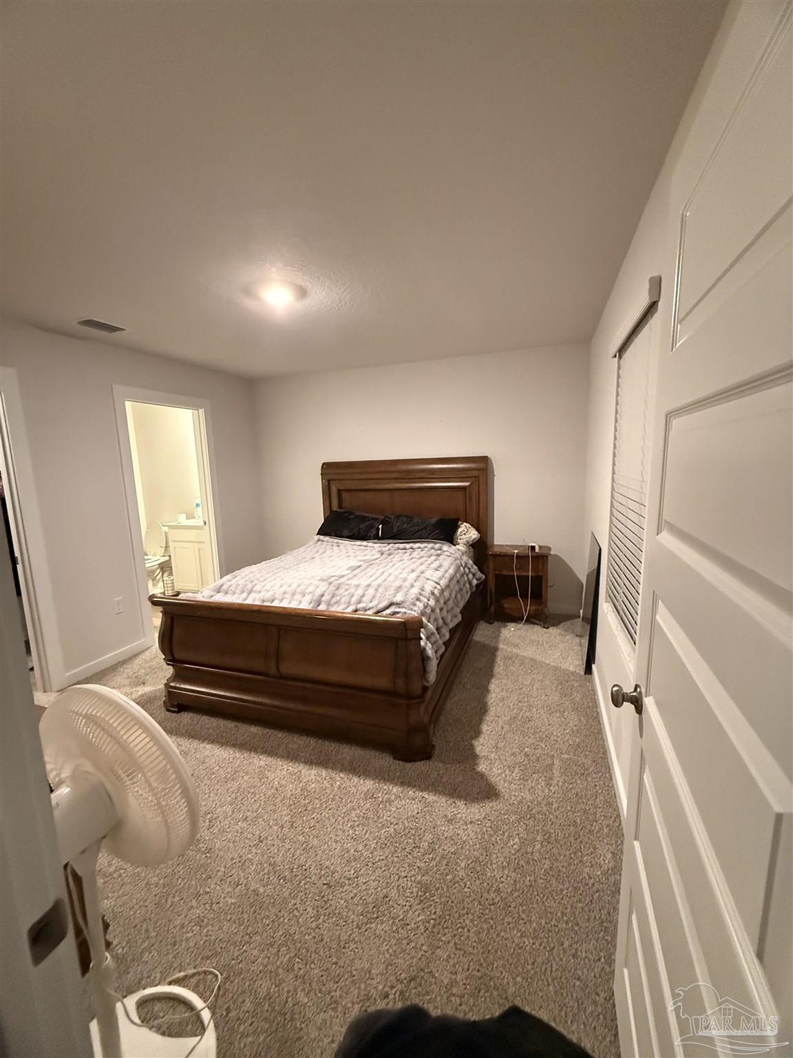 8 Spoonbill Street Cantonment, FL 32533 - Photo 16 of 22 a bedroom with a bed and wooden floor
