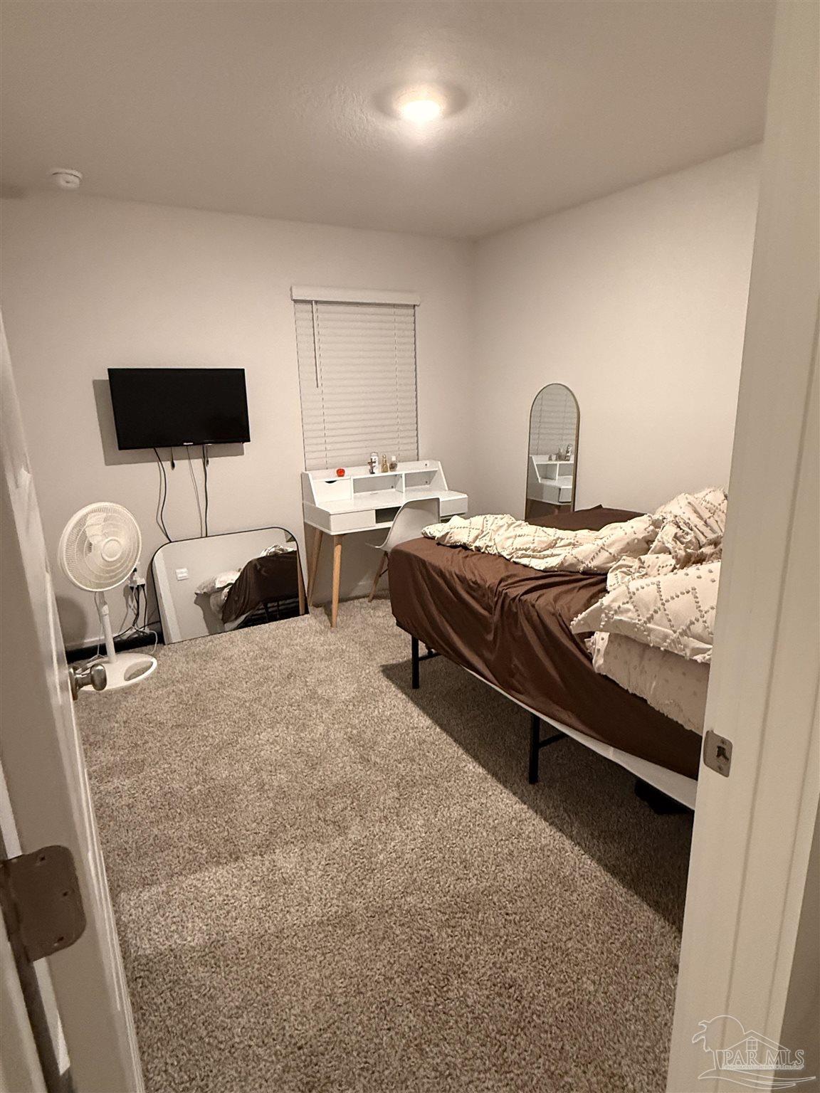 8 Spoonbill Street Cantonment, FL 32533 - Photo 19 of 22 a bed room with furniture and a flat screen tv