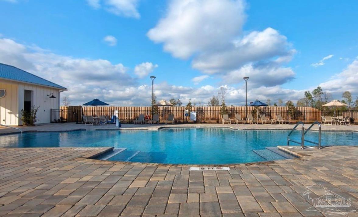 8 Spoonbill Street Cantonment, FL 32533 - Photo 22 of 22 a view of a swimming pool with a lounge chairs