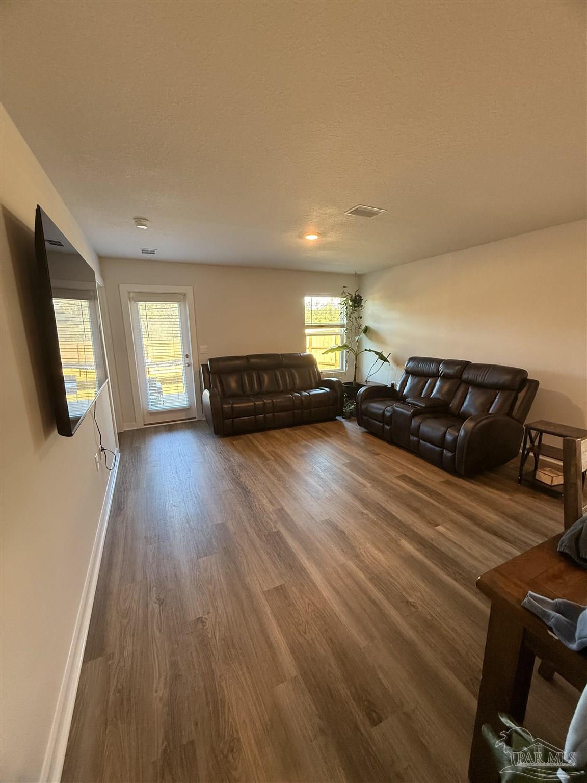8 Spoonbill Street Cantonment, FL 32533 - Photo 7 of 22 a living room with furniture and a wooden floor