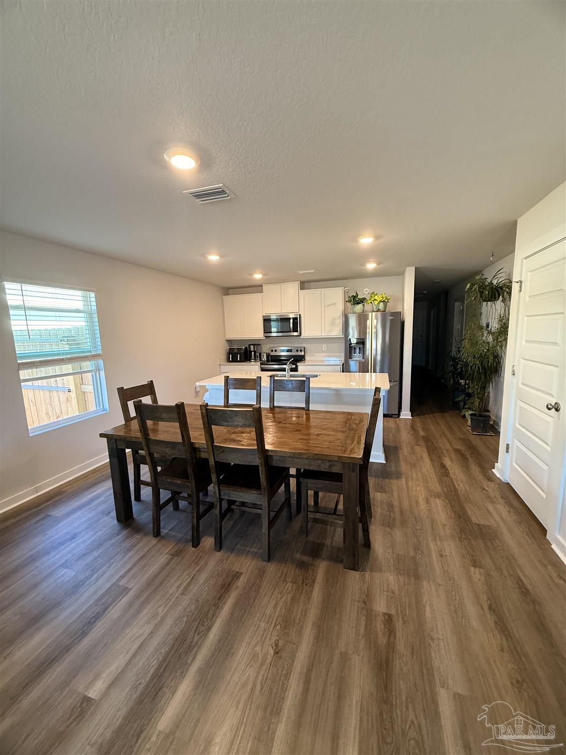8 Spoonbill Street Cantonment, FL 32533 - Photo 9 of 22 a view of a dining room with furniture and wooden floor