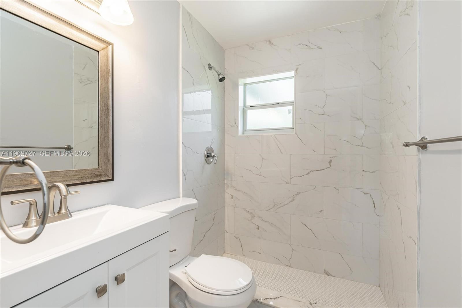 5615 Simms Street Hollywood, FL 33021 - Photo 14 of 27 a bathroom with a sink a toilet and shower