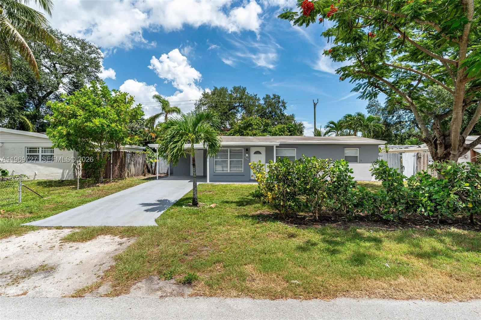 5615 Simms Street Hollywood, FL 33021 - Photo 2 of 27 a view of a house with a yard