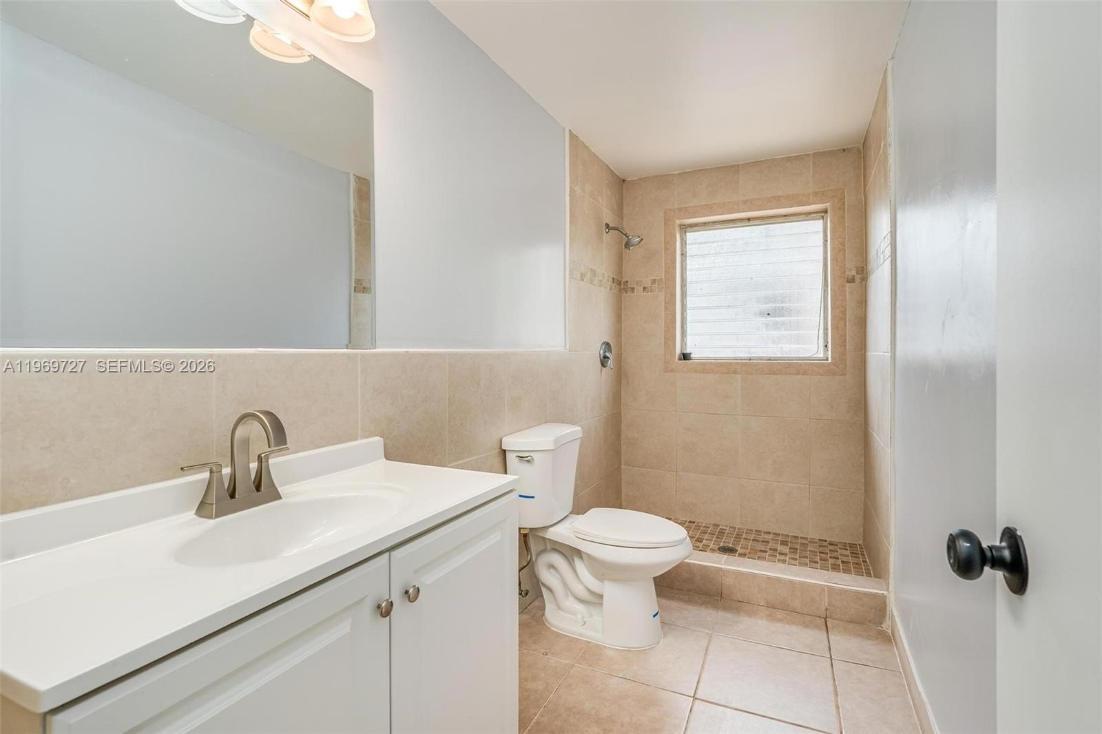 5615 Simms Street Hollywood, FL 33021 - Photo 27 of 27 a bathroom with a sink a toilet and a mirror