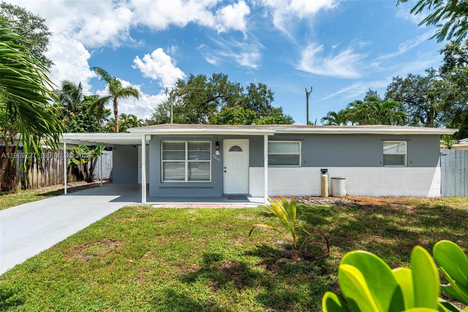 5615 Simms Street Hollywood, FL 33021 - Photo 3 of 27 a front view of house with yard outdoor seating and barbeque oven
