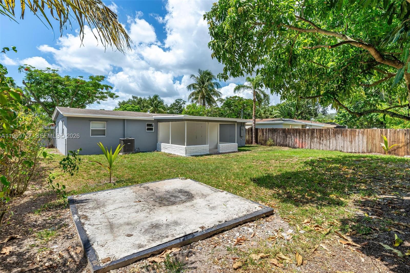 5615 Simms Street Hollywood, FL 33021 - Photo 7 of 27 front view of a house with a yard
