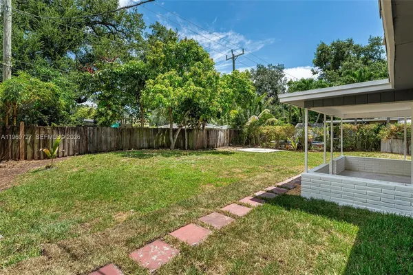 a view of a backyard with a garden and entertaining space