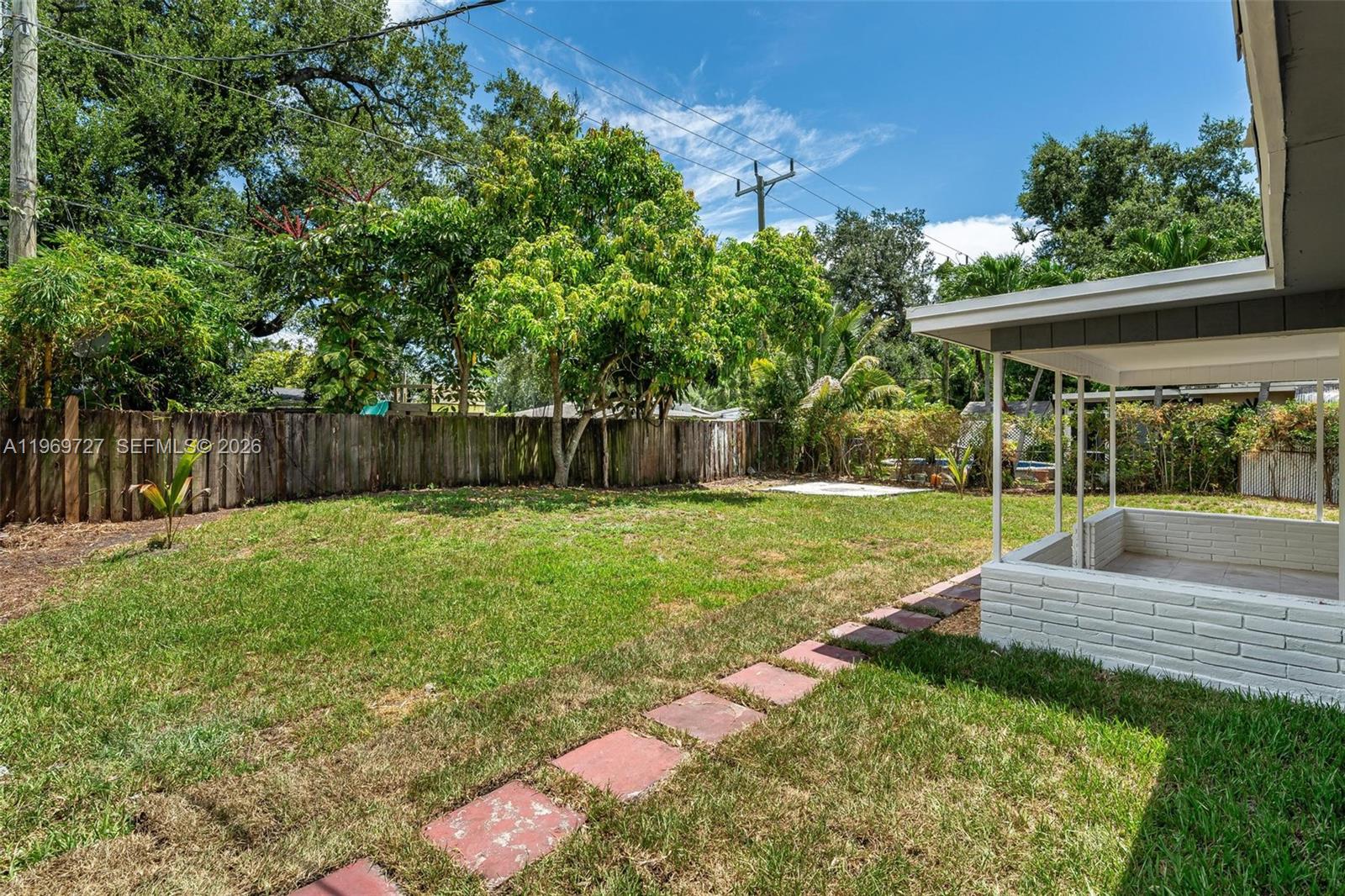5615 Simms Street Hollywood, FL 33021 - Photo 9 of 27 a view of a backyard with a garden and entertaining space