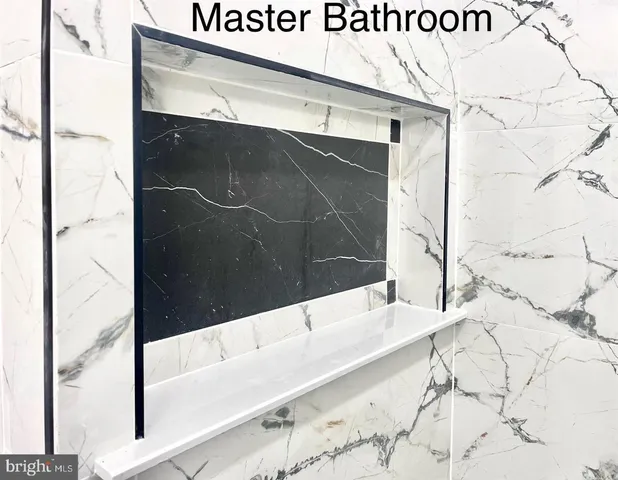 a bathroom with a bathtub and shower