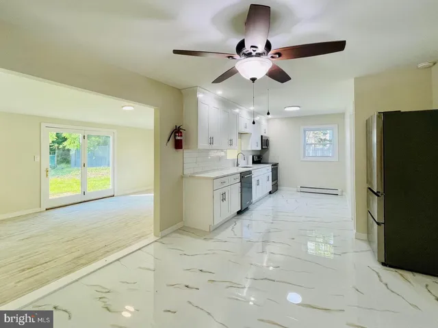 a kitchen with appliances a sink and cabinets