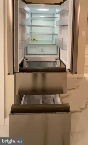 an empty room with windows and a fireplace