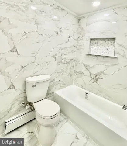 a view of a big room with wooden floor and a kitchen