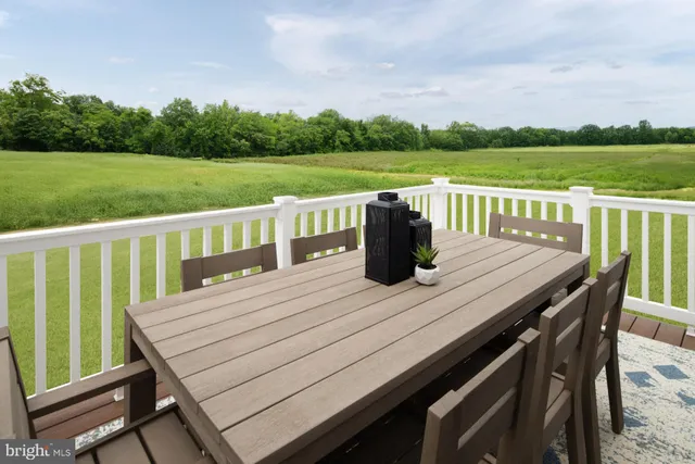 a view of a deck with mountain view and a garden