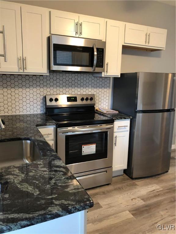 919 Spring Street Bethlehem, PA 18018 - Photo 3 of 41 a kitchen with granite countertop a stove and a microwave
