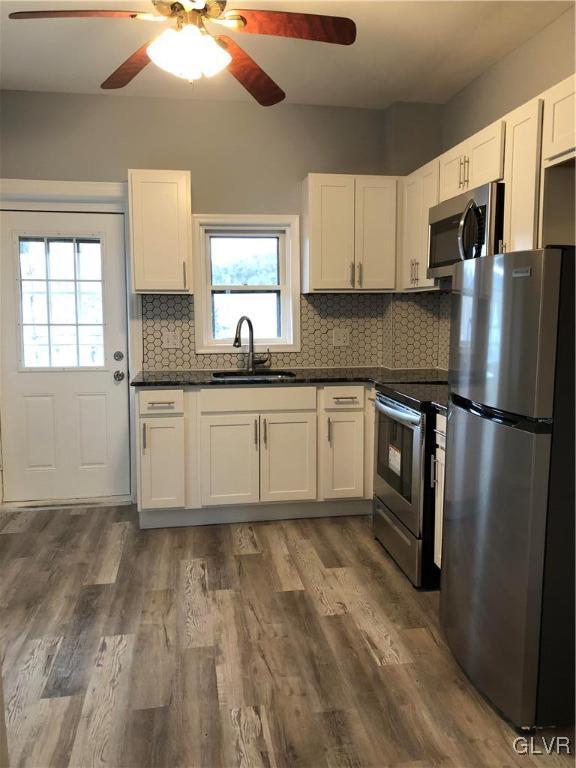 919 Spring Street Bethlehem, PA 18018 - Photo 6 of 41 a kitchen with granite countertop a refrigerator a sink a stove and cabinets
