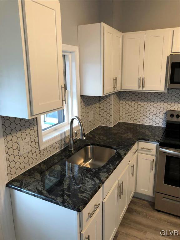 919 Spring Street Bethlehem, PA 18018 - Photo 8 of 41 a kitchen with granite countertop a sink stove and cabinets