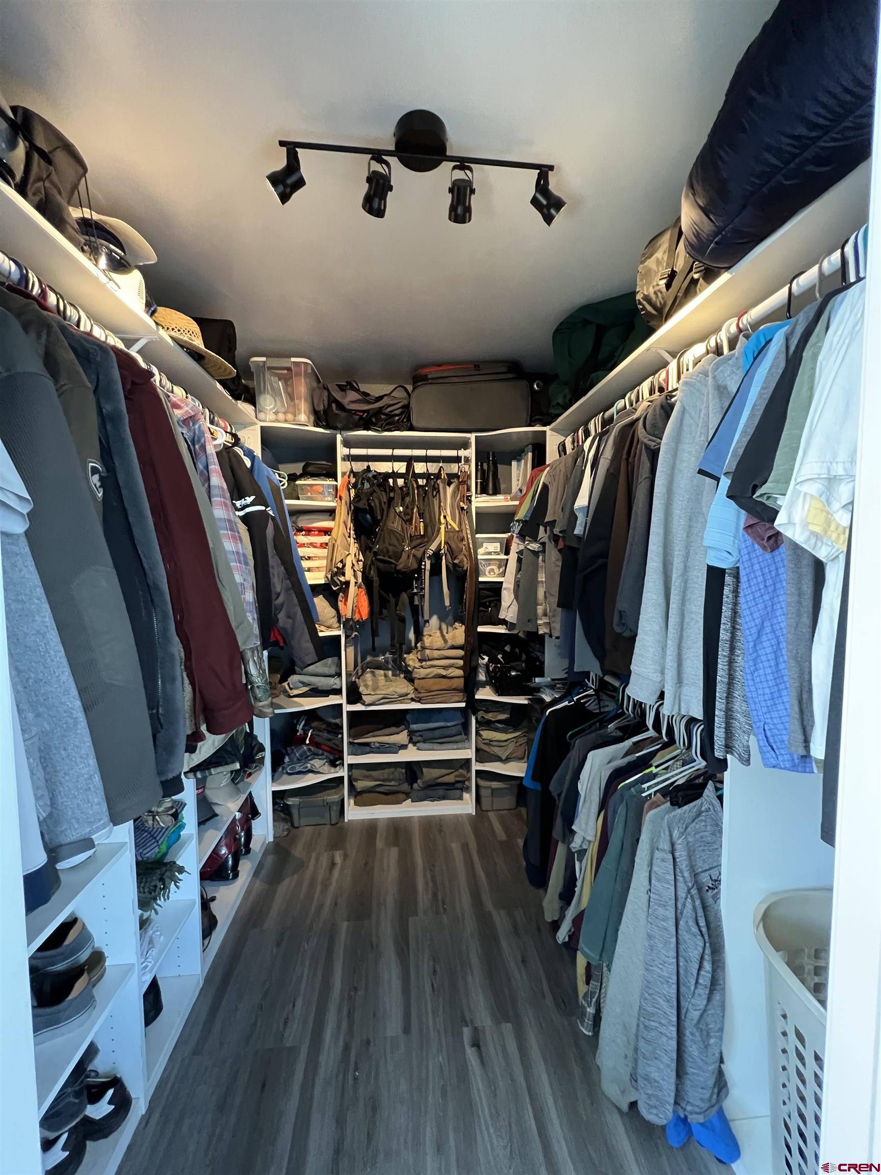 22350 Surface Creek Road Cedaredge, CO 81413 - Photo 18 of 32 a view of walk in closet with clothes and shoes