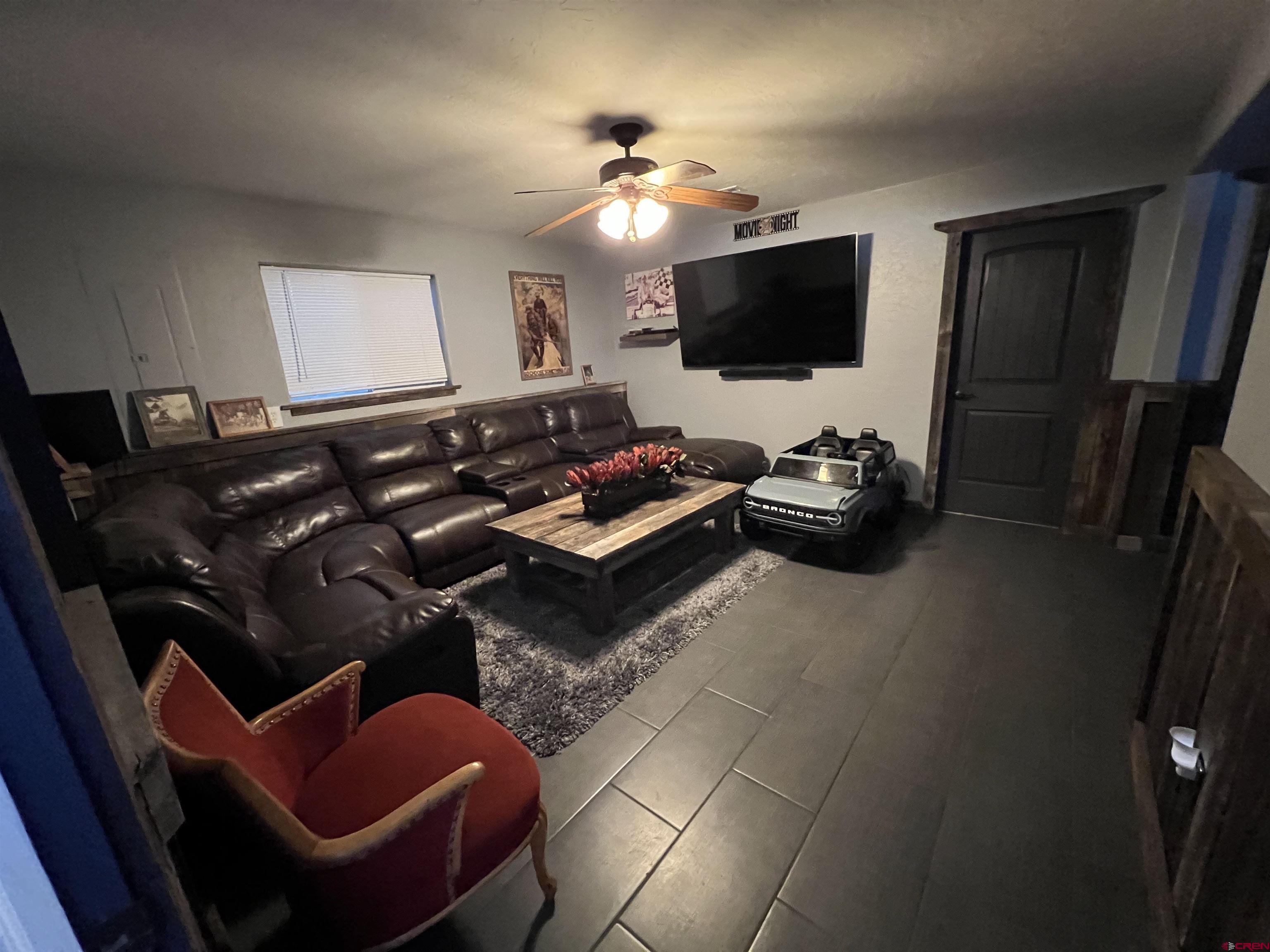 22350 Surface Creek Road Cedaredge, CO 81413 - Photo 21 of 32 a living room with furniture and a flat screen tv