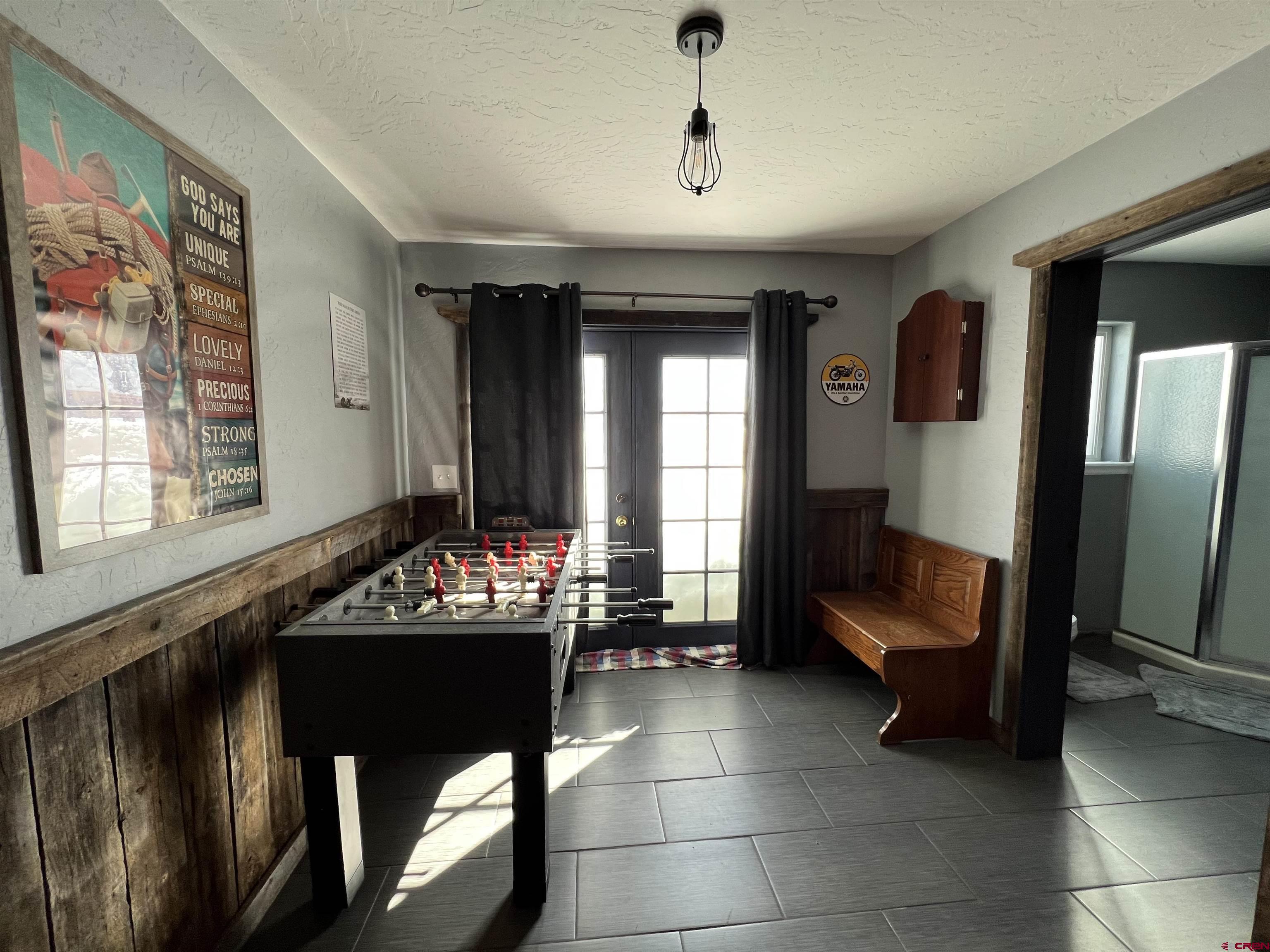 22350 Surface Creek Road Cedaredge, CO 81413 - Photo 24 of 32 a living room with furniture and a flat screen tv