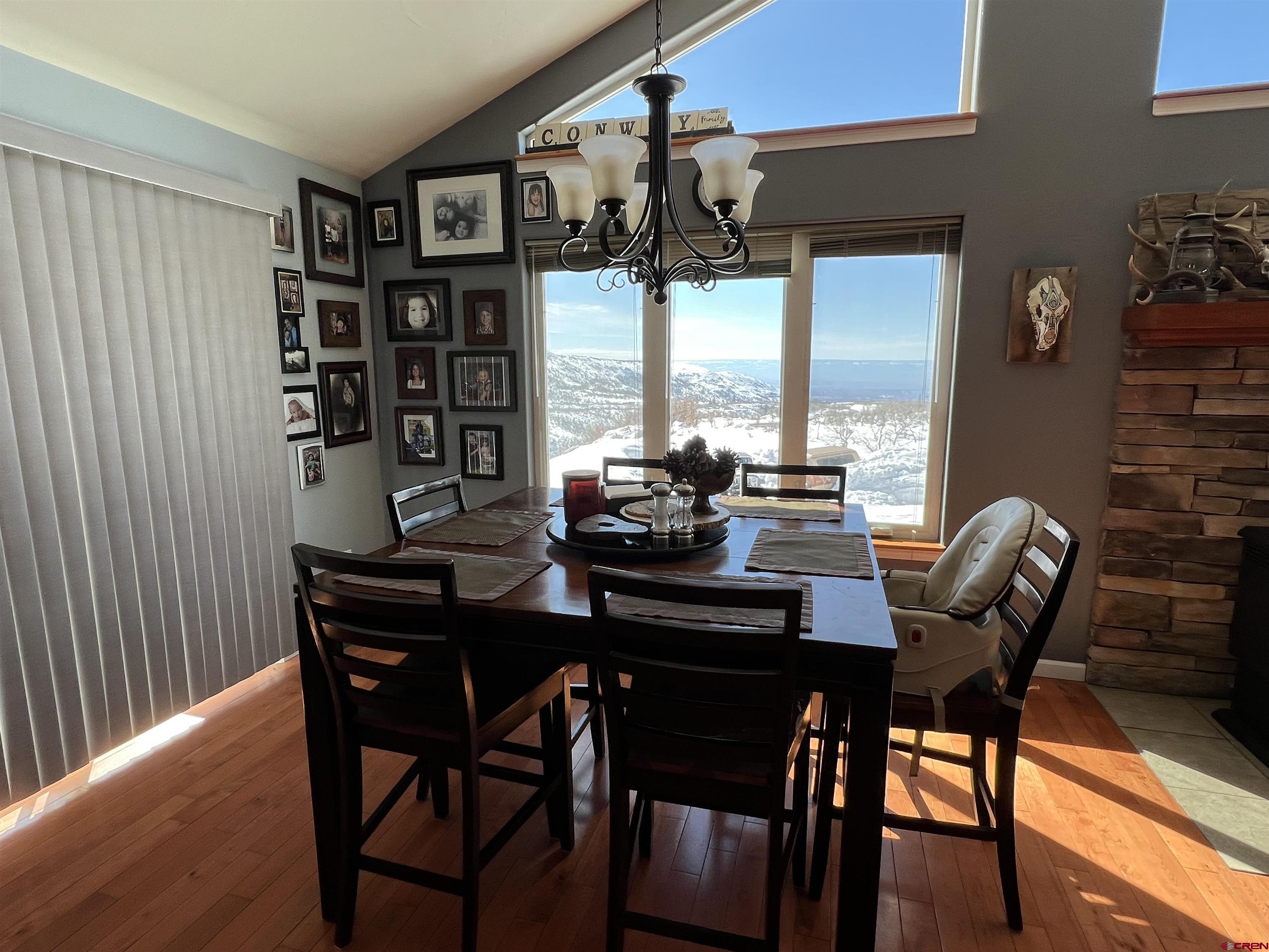 22350 Surface Creek Road Cedaredge, CO 81413 - Photo 8 of 32 a dining room with a wooden table and chairs