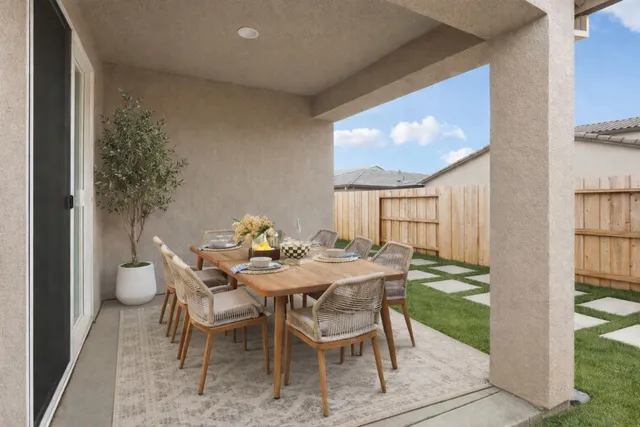 a view of a dining room with furniture large windows and wooden floor