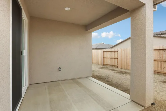 a view of a big room with wooden floor and windows