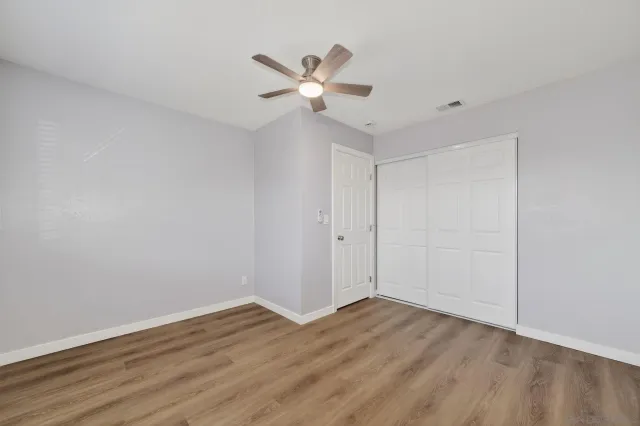 a view of a room with wooden floor and windows