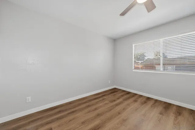 a view of a house with a wooden fence