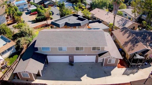 an aerial view of residential houses with outdoor space