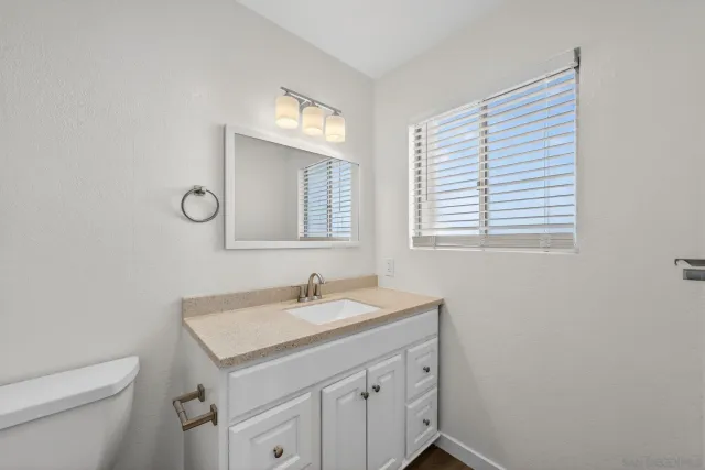 a bathroom with a sink vanity and a mirror
