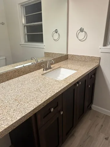 a view of a livingroom with table & chair and cabinet