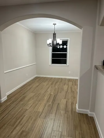 a view of a room with wooden floor
