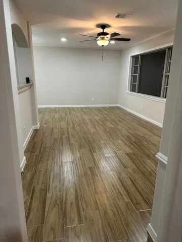 wooden floor in an empty room with a window