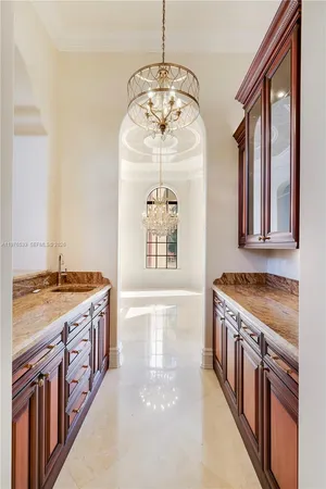 a spacious bedroom with a bed and glass walk in closet